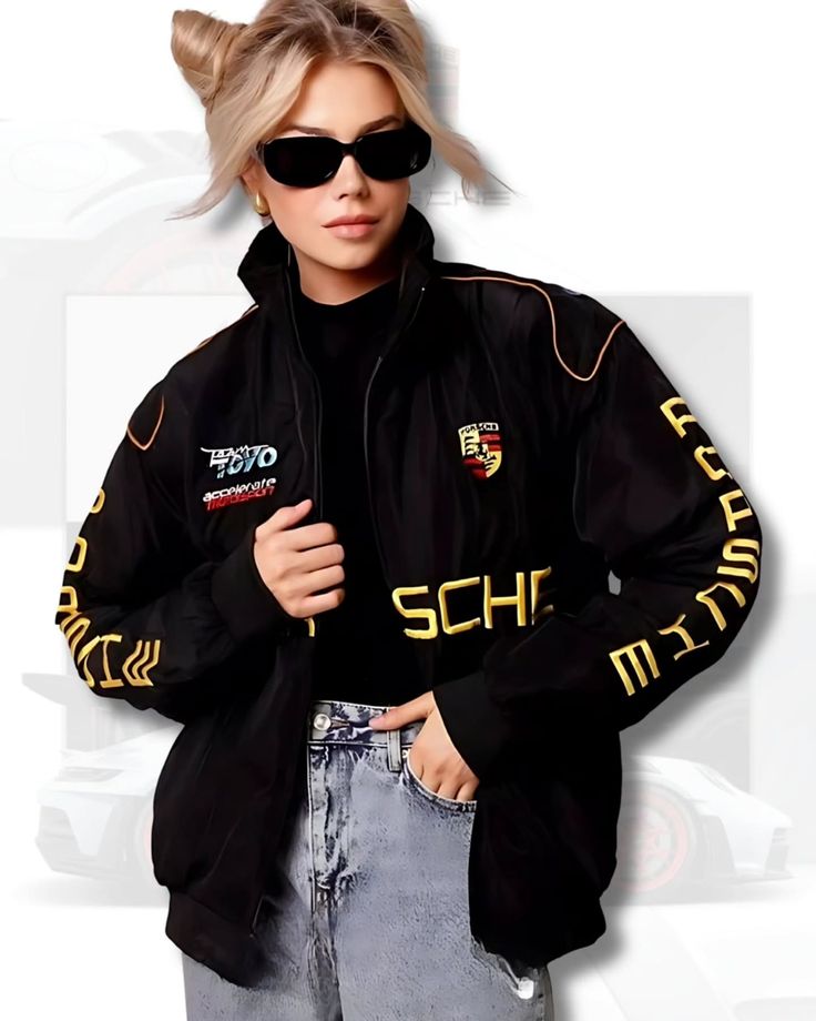 Person wearing a black porsche jacket with logos and text, sitting on a white background