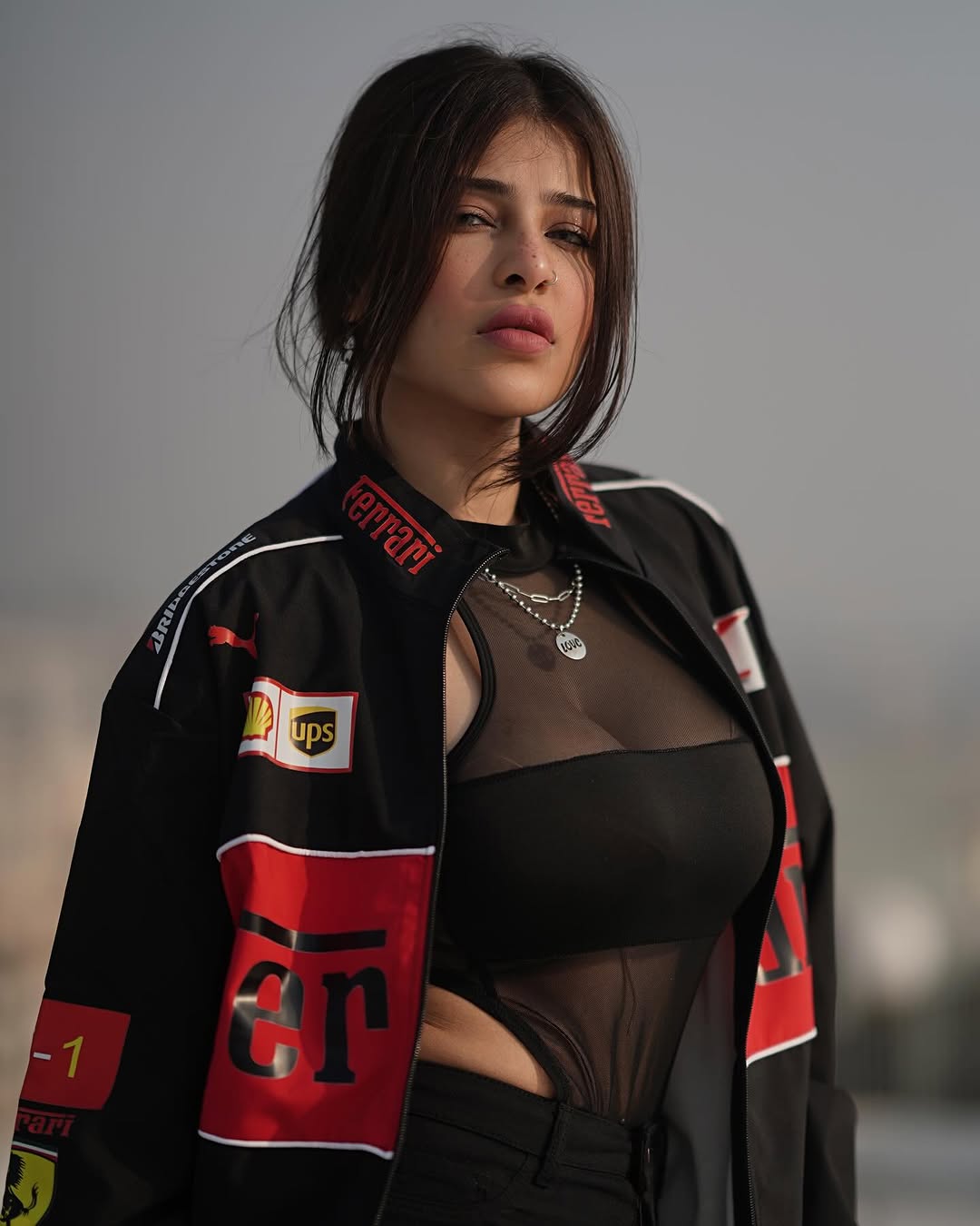 Side view of model in black Ferrari Scuderia jacket outdoors