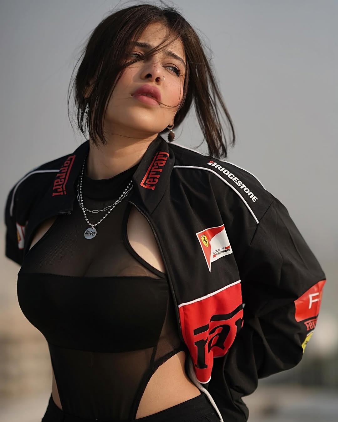 Studio shot of model in black Ferrari jacket, front view